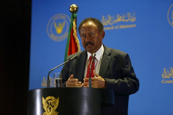 epa08997288 Sudanese Prime Minister, Abdullah Hamdok, speaks during a press conference at the headquarters of the Council of Ministers in Khartoum, Sudan, 08 February 2021 to announce the formation of ...