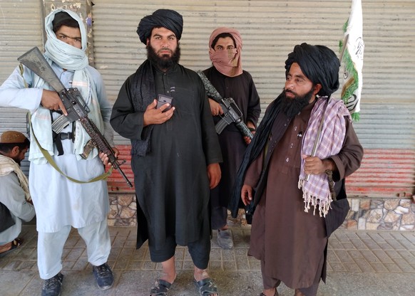 Taliban fighters patrol inside the city of Farah, the capital of Farah province, southwest of Kabul, Afghanistan, Wednesday, Aug. 11, 2021. (AP Photo/Mohammad Asif Khan)