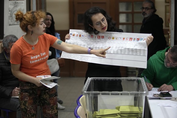 Election representatives count the votes at a polling station in Istanbul, Turkey, Sunday, May 14, 2023. Election polls closed Sunday in Turkey, where President Recep Tayyip Erdogan's 20-year lea ...