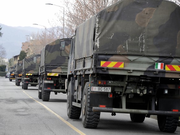 FILE - In this March 26, 2020 file photo, military trucks moving coffins of deceased people leave the cemetery of Bergamo, one of the areas worst hit by the coronavirus infection, on their way to a cr ...