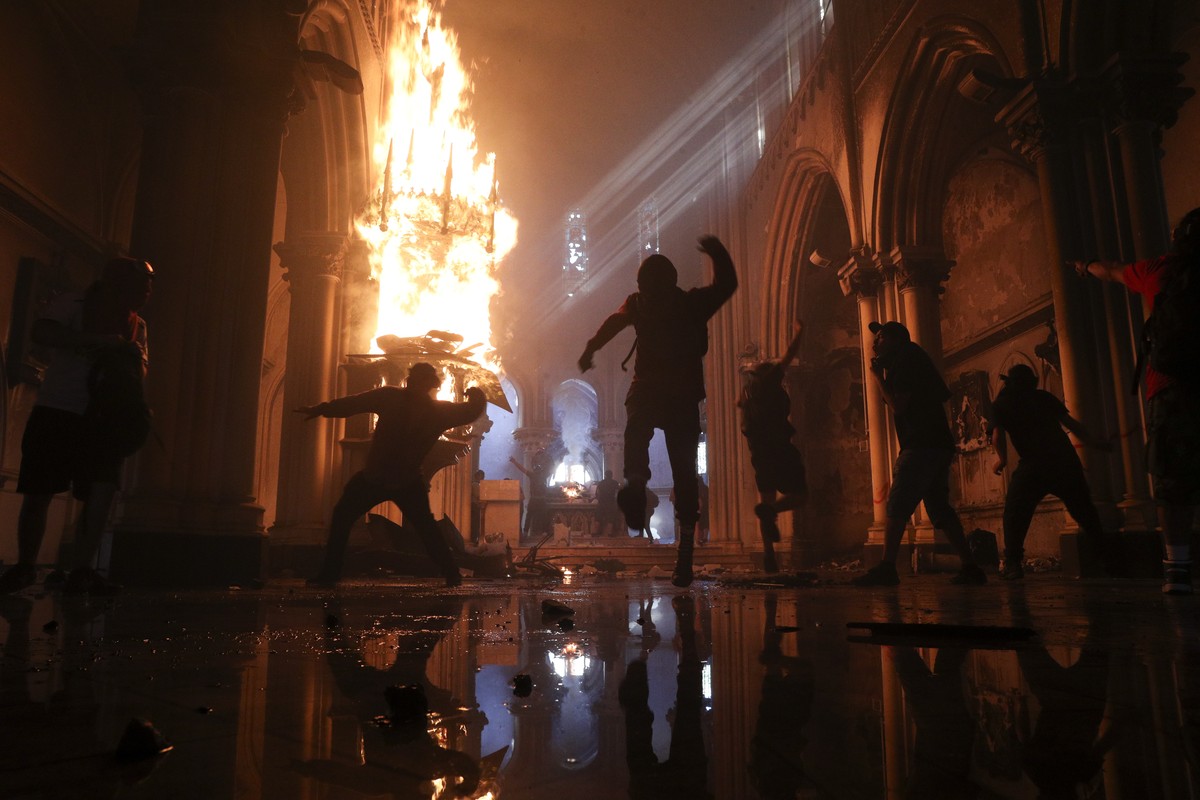 Protesters storm the San Francisco de Borja church, that belongs to Carabineros, Chile's national police force, on the one-year anniversary of the start of anti-government mass protests over ineq ...