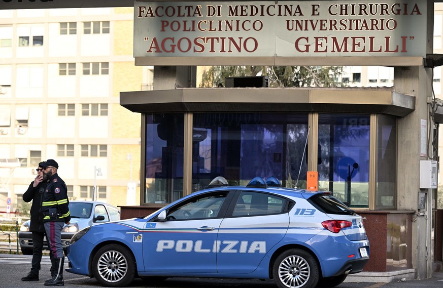 epa10549472 Policemen stand in front of the Agostino Gemelli hospital in Rome, Italy, 29 March 2023. Pope Francis is hospitalized following a respiratory infection (excluding the Covid 19 infection) w ...