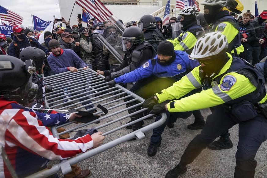 Trump supporters try to break through a police barrier, Wednesday, Jan. 6, 2021, at the Capitol in Washington. As Congress prepares to affirm President-elect Joe Biden's victory, thousands of peo ...