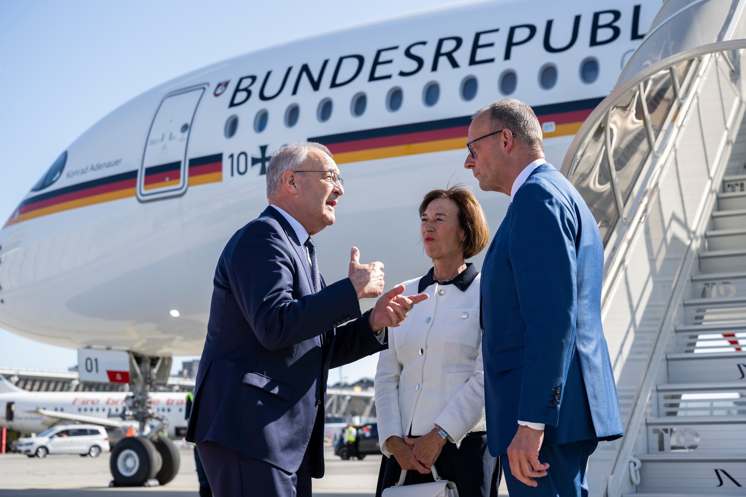 Swiss Federal President Guy Parmelin, left, welcomes Germany's Chancellor Friedrich Merz and his wife Charlotte Merz at the Geneva Airport, Switzerland, prior the G7 summit, Monday, June 15, 2026 ...