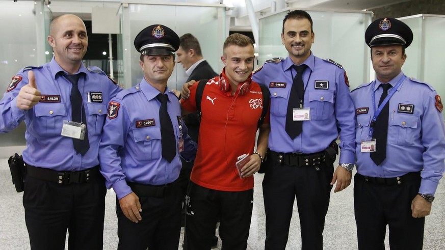 Swiss footballer Xherdan Shaqiri poses with customs officers after landing in Tirana 2 days prior to a world cup qualifier match against Albania, wednesday, october 9, 2013 on the airport in Tirana, A ...