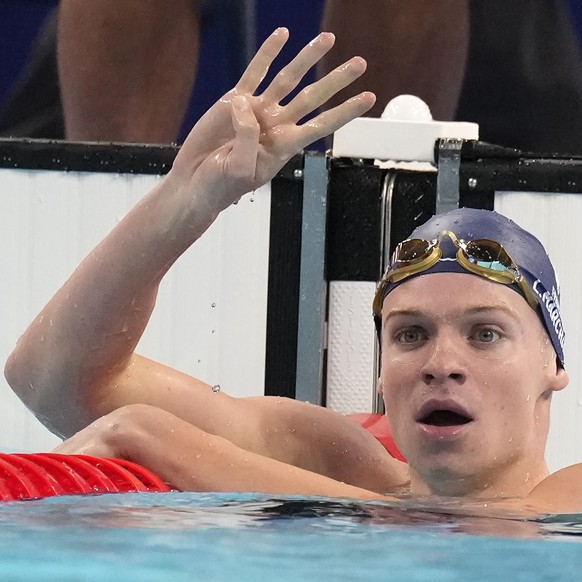 Leon Marchand of France, celebrates after winning the men&#039;s 200-meter individual medley final at the 2024 Summer Olympics, Friday, Aug. 2, 2024, in Nanterre, France. (AP Photo/Natacha Pisarenko)