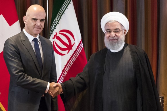 epa07048834 Swiss Federal President Alain Berset (L) and Iranian President Hassan Rouhani (R) shake hands prior to a bilateral meeting on the sidelines of the 73rd session of the General Assembly of t ...
