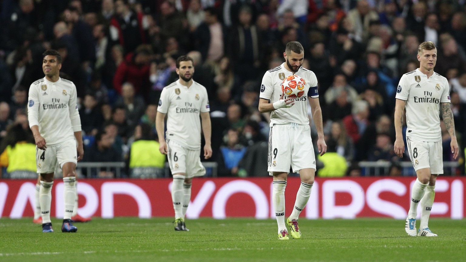 Real forward Karim Benzema holds the ball after being scored by Ajax, during the Champions League soccer match between Real Madrid and Ajax at the Santiago Bernabeu stadium in Madrid, Spain, Tuesday,  ...