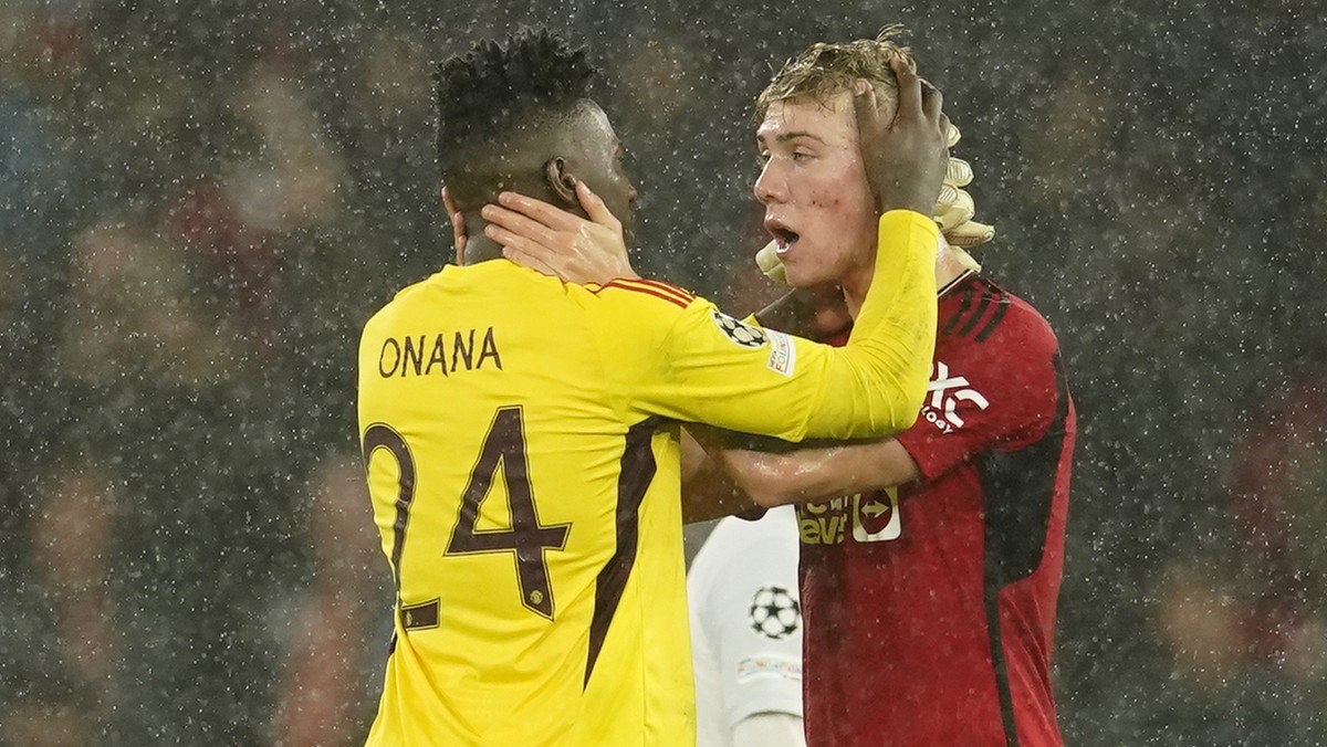 Manchester United's goalkeeper Andre Onana reacts with his teammate Rasmus Hojlund during the Champions League group A soccer match between Manchester United and Galatasaray at the Old Trafford s ...