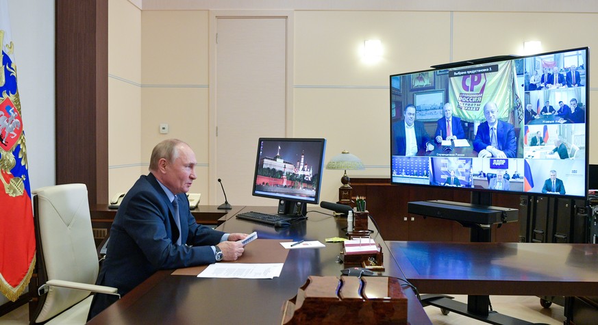 epa09487825 Russian President Vladimir Putin meets with the leaders of the political parties, via teleconference call, at the Novo-Ogaryovo state residence, outside Moscow, Russia 25 September 2021. E ...