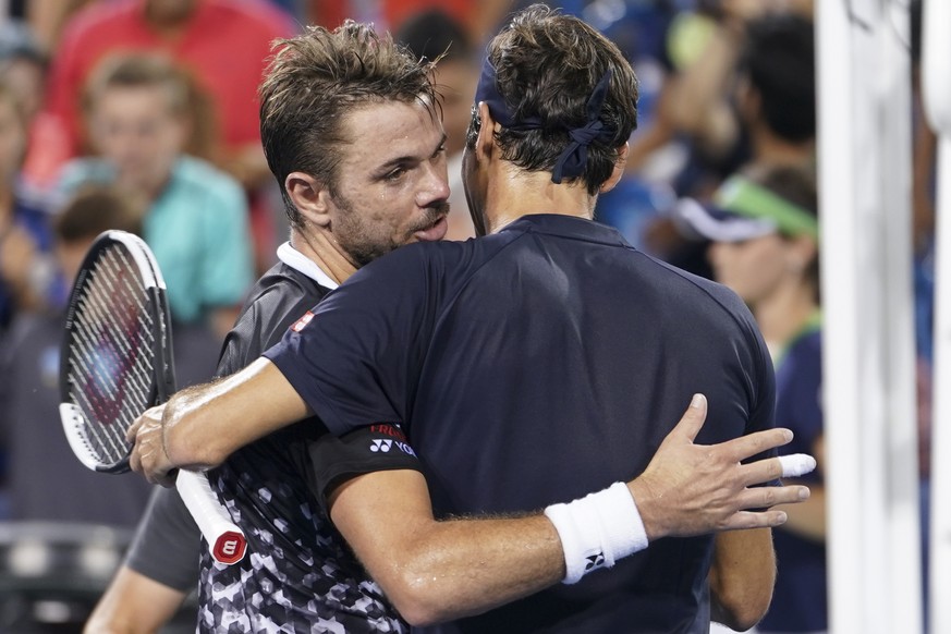 Roger Federer, right, of Switzerland, hugs Stan Wawrinka, of Switzerland, after Federer won their quarterfinal at the Western &amp; Southern Open tennis tournament Friday, Aug. 17, 2018, in Mason, Ohi ...