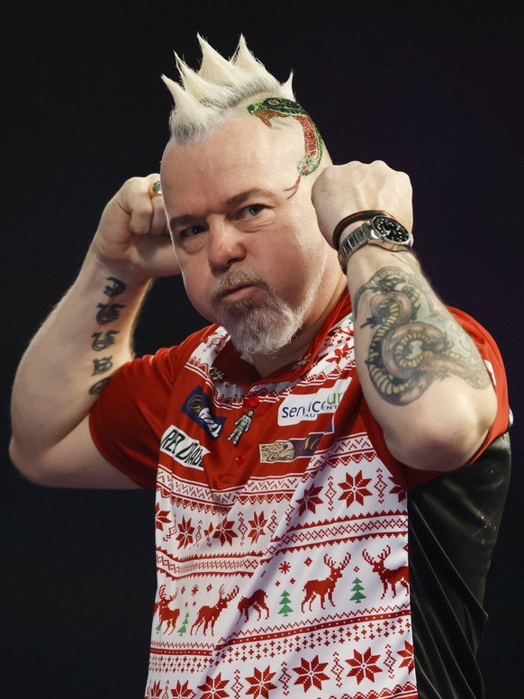 Scotland&#039;s Peter Wright celebrates his victory in his match against Diogo Portela of Brazil during day eight of the World Darts Championship at Alexandra Palace, London, Thursday Dec. 21, 2017. ( ...