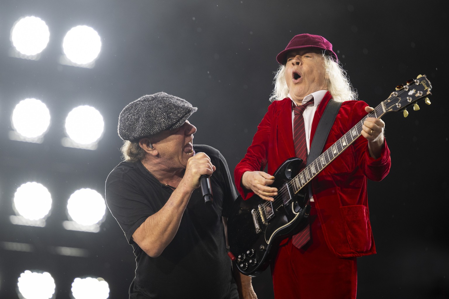 epa11445864 British singer Brian Johnson (L) and Scottish-born Australian guitarist Angus Young (R) of Australian hard rock band AC/DC perform on stage during the concert at Letzigrund stadium in Zuri ...