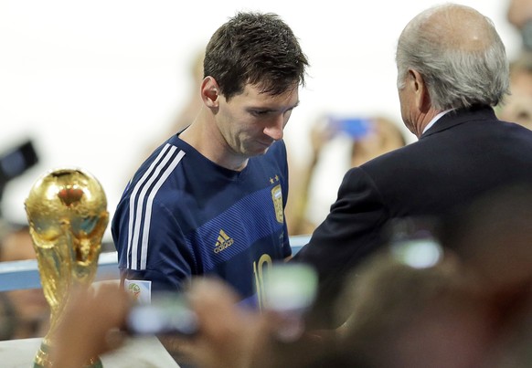 FILE - In this Sunday, July 13, 2014. File photo, Argentina&#039;s Lionel Messi collects the second place trophy after the World Cup final soccer match between Germany and Argentina at the Maracana St ...