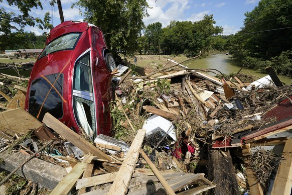A car is among debris that washed up against a bridge over a stream Sunday, Aug. 22, 2021, in Waverly, Tenn. Heavy rains caused flooding Saturday in Middle Tennessee and have resulted in multiple deat ...
