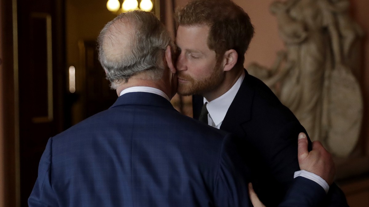 Britain's Prince Harry kisses and greets his father Prince Charles upon their separate arrival to attend a coral reef health and resilience meeting with speeches and a reception with delegates at ...