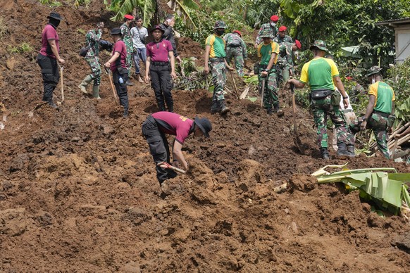 Rescue workers search for victims of an earthquake-triggered landslide in Cianjur, West Java, Indonesia, Wednesday, November 23, 2022. More rescue workers and volunteers were deployed to devastated areas on Wednesday, Nov. 23, 2022.