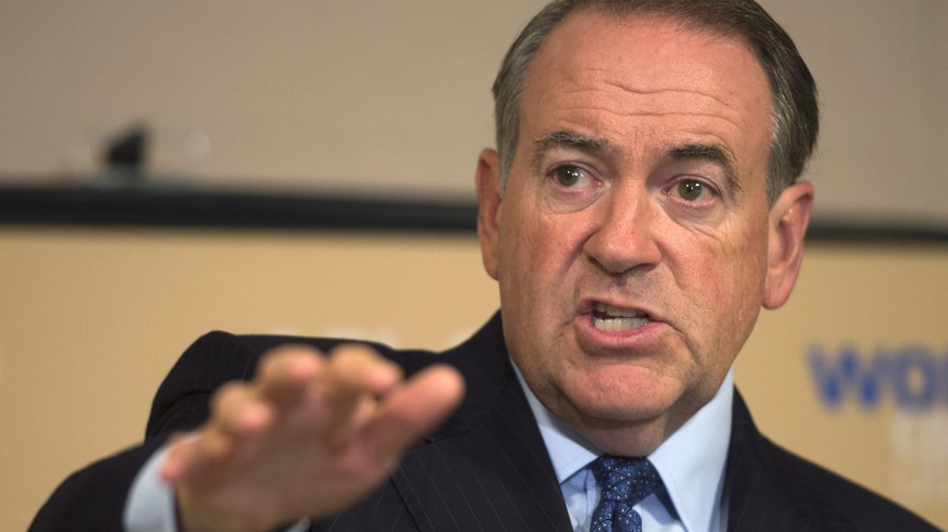 epa04865294 Republican presidential candidate Mike Huckabee responds to a question from the news media after delivering remarks to the AFL-CIO Executive Council meeting at the ATU Tommy Douglas Confer ...