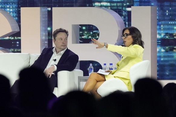 FILE - Elon Musk, left, speaks with Linda Yaccarino, April 18, 2023, in Miami Beach, Fla. The new CEO of the company formerly known as Twitter says she&#039;s spent much of the past eight weeks trying ...