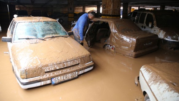 SANLIURFA, TURKIYE - MARCH 17: Vehicles stuck in mud at flooded parking garage near Sanliurfa Archeology Museum after heavy rains caused flood in Sanliurfa, Turkiye on March 17, 2023. (Photo by Esber  ...