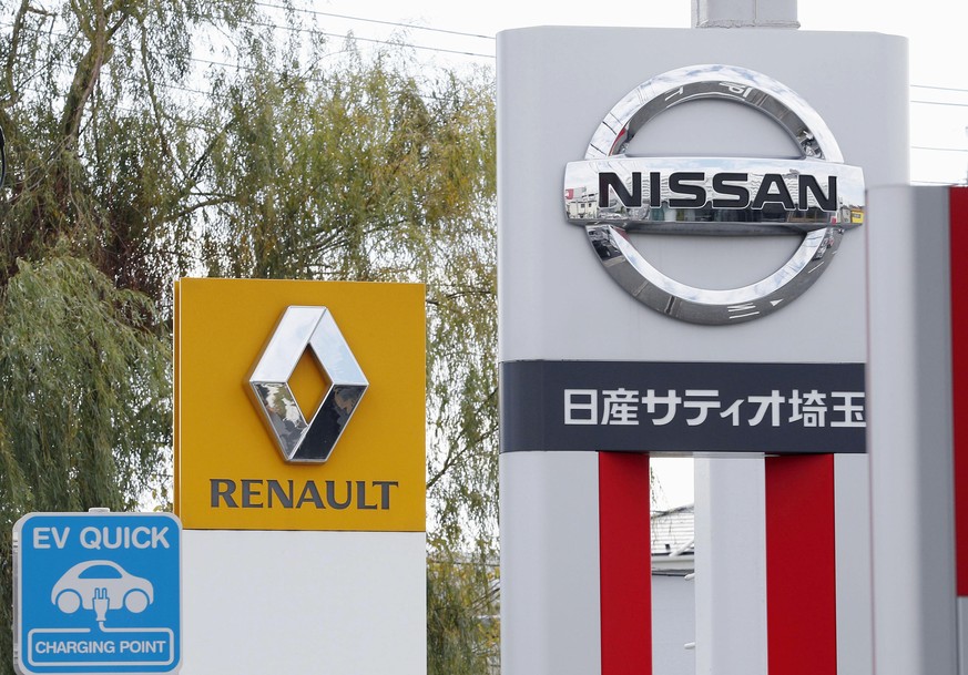 This Nov. 20, 2018, photo shows the logos of Nissan Motor Co. and Renault at car dealerships in Kawaguchi, north of Tokyo. Japanese automaker Nissan wasn’t consulted about a proposed merger between it ...