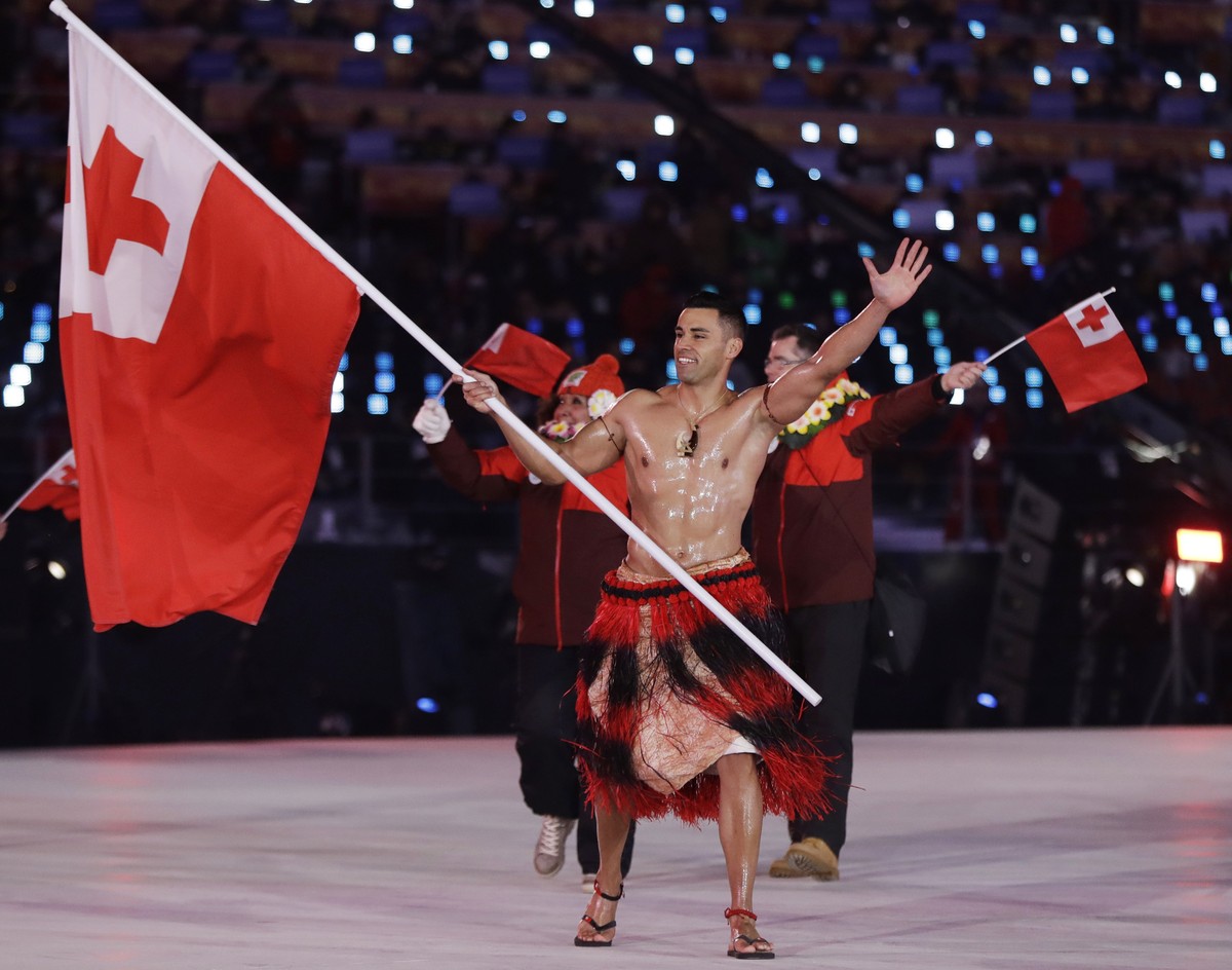 Pita Taufatofua carries the flag of Tonga during the opening ceremony of the 2018 Winter Olympics in Pyeongchang, South Korea, Friday, Feb. 9, 2018. (AP Photo/Petr David Josek)