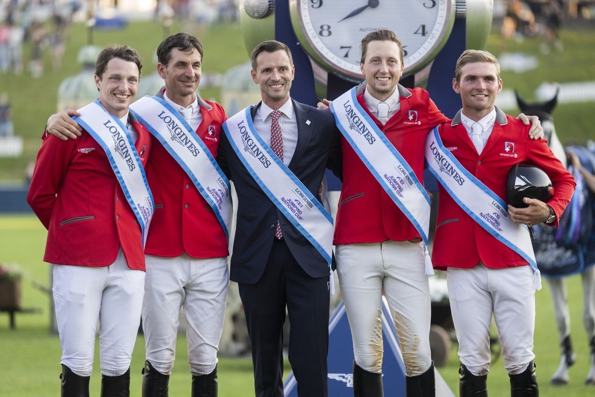 The winning team with Edouard Schmitz, Steve Guerdat, Chef d'Equipe Michel Sorg, Martin Fuchs, and Bryan Balsiger, from left, celebreates at the "Longines FEI Jumping Nations Cup of Switzerl ...