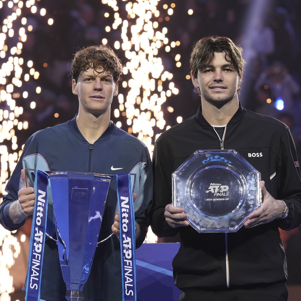 Italy's Jannik Sinner, the winner, and runner-up Taylor Fritz of the United States pose after the ATP World Tour Finals final match at the Inalpi Arena, in Turin, Italy, Sunday, Nov. 17, 2024. (A ...