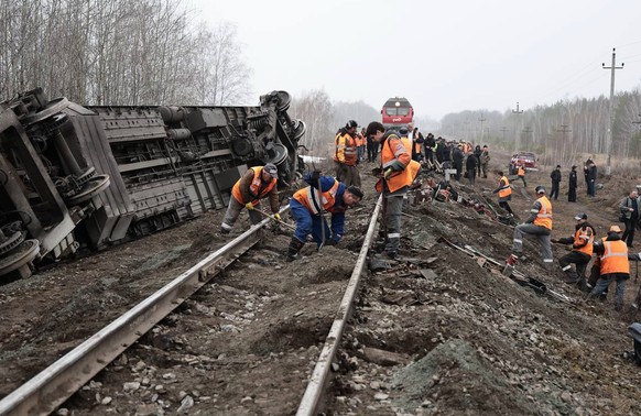 In this photo released by Ulyanovsk regional governor Alexey Russkikh's Telegram channel on Friday, April 3, 2026, railway employees work at the passenger train derailment site near Bryandino vil ...