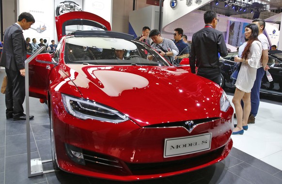 epa07295009 (FILE) - People look at a Tesla model S electric car on display at the Auto China 2016 motor show in Beijing, China, 26 April 2016 (reissued 18 January 2019). Tesla has issued a recall of  ...