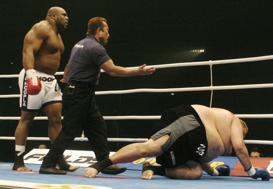 Sumo&#039;s former grand champion Akebono, right, tries to get up as his opponent Bob Sapp, a former NFL lineman, watches during their match at Nagoya Dome in central Japan on Wednesday December 31, 2 ...
