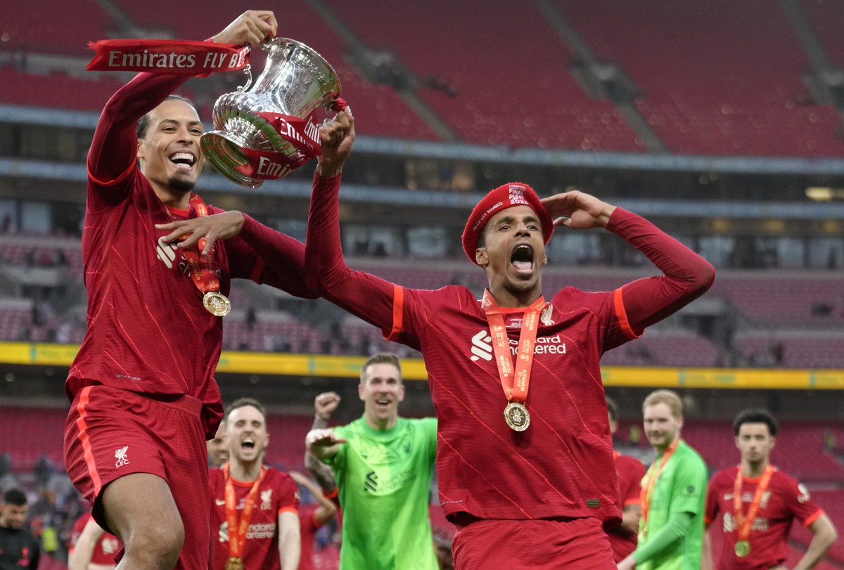Liverpool's Virgil van Dijk, left, and Liverpool's Joel Matip celebrate at the end of the English FA Cup final soccer match between Chelsea and Liverpool, at Wembley stadium, in London, Satu ...