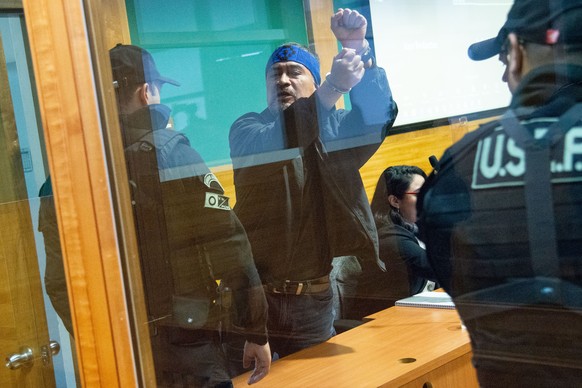 epa11294581 The leader of the Coordinadora Arauco Malleco (CAM) Hector Llaitul (C) reacts upon hearing the verdict against him, in the Public Order Court (TOP) in Temuco, Chile, 22 April 2024. The rad ...