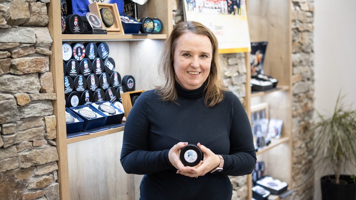 Katerina Zubickova, co-owner of the Czech company Gufex producing ice hockey pucks for the 2026 Olympic Games, poses with a Milan-Cortina puck at the company headquarters in Katerinice village in east ...
