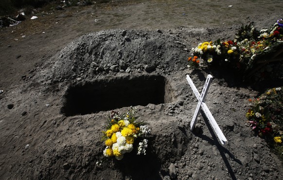 A grave is empty next to graves with fresh flowers on them at the Valle de Chalco municipal cemetery amid the new coronavirus pandemic, on the outskirts of Mexico City, Friday, Oct. 30, 2020. Mexican  ...