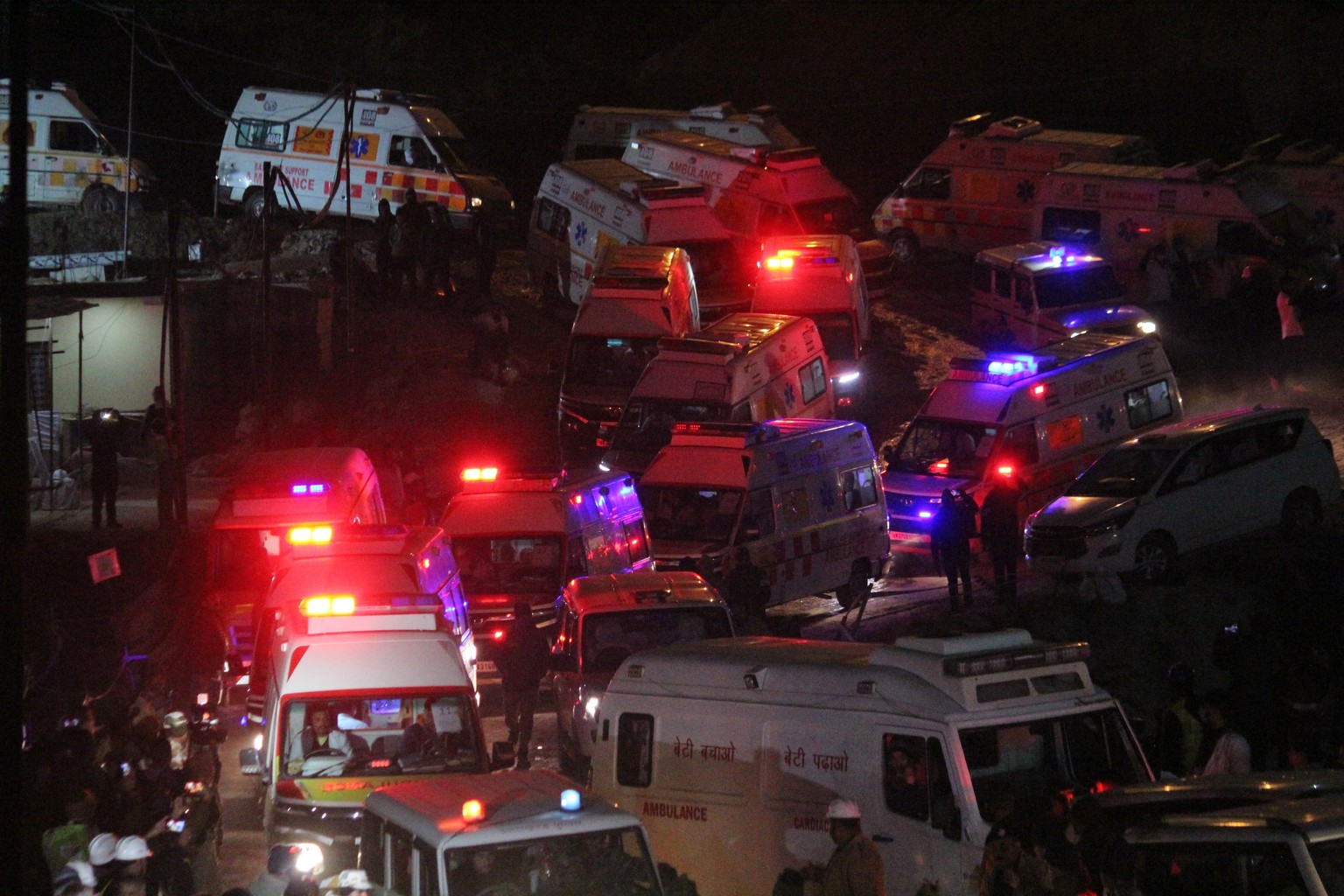 A line of ambulances drive past carrying workers rescued from the site of an under-construction road tunnel that collapsed in Silkyara in the northern Indian state of Uttarakhand, India, Tuesday, Nov. ...