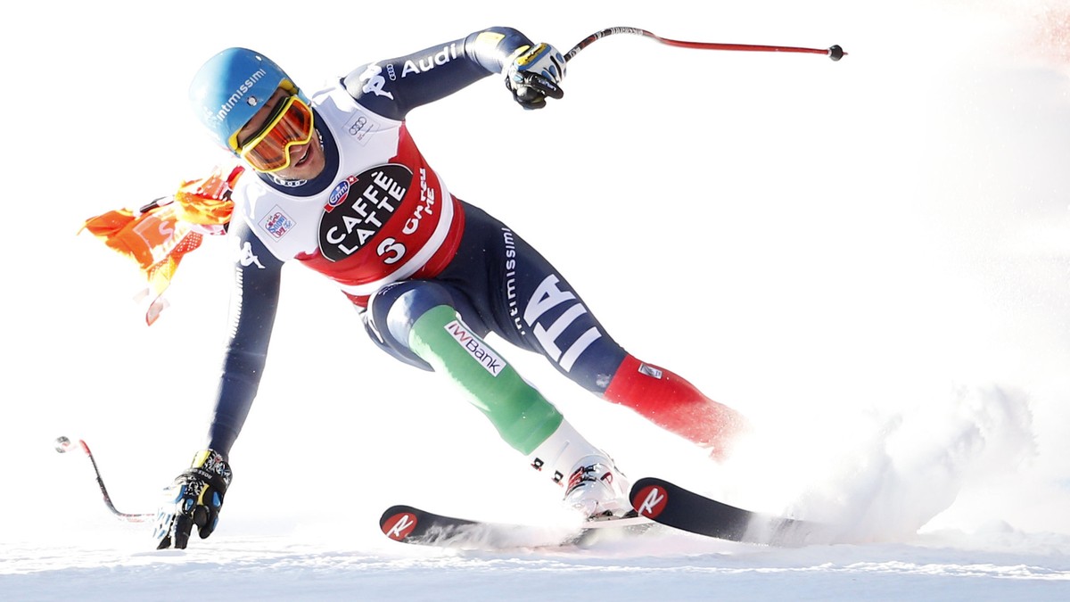 Christof Innerhofer of Italy speeds down with a part of a gate that remained entrapped in his race glasses during the men's downhill race at the Alpine Skiing World Cup in Santa Caterina Valfurva ...