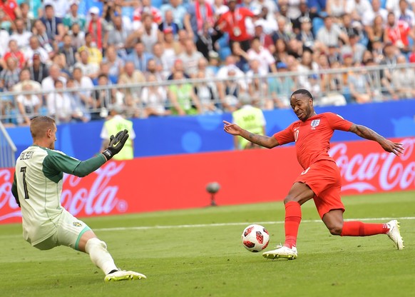 epa06871312 Goalkeeper Robin Olsen (L) of Sweden and Raheem Sterling of England in action during the FIFA World Cup 2018 quarter final soccer match between Sweden and England in Samara, Russia, 07 Jul ...