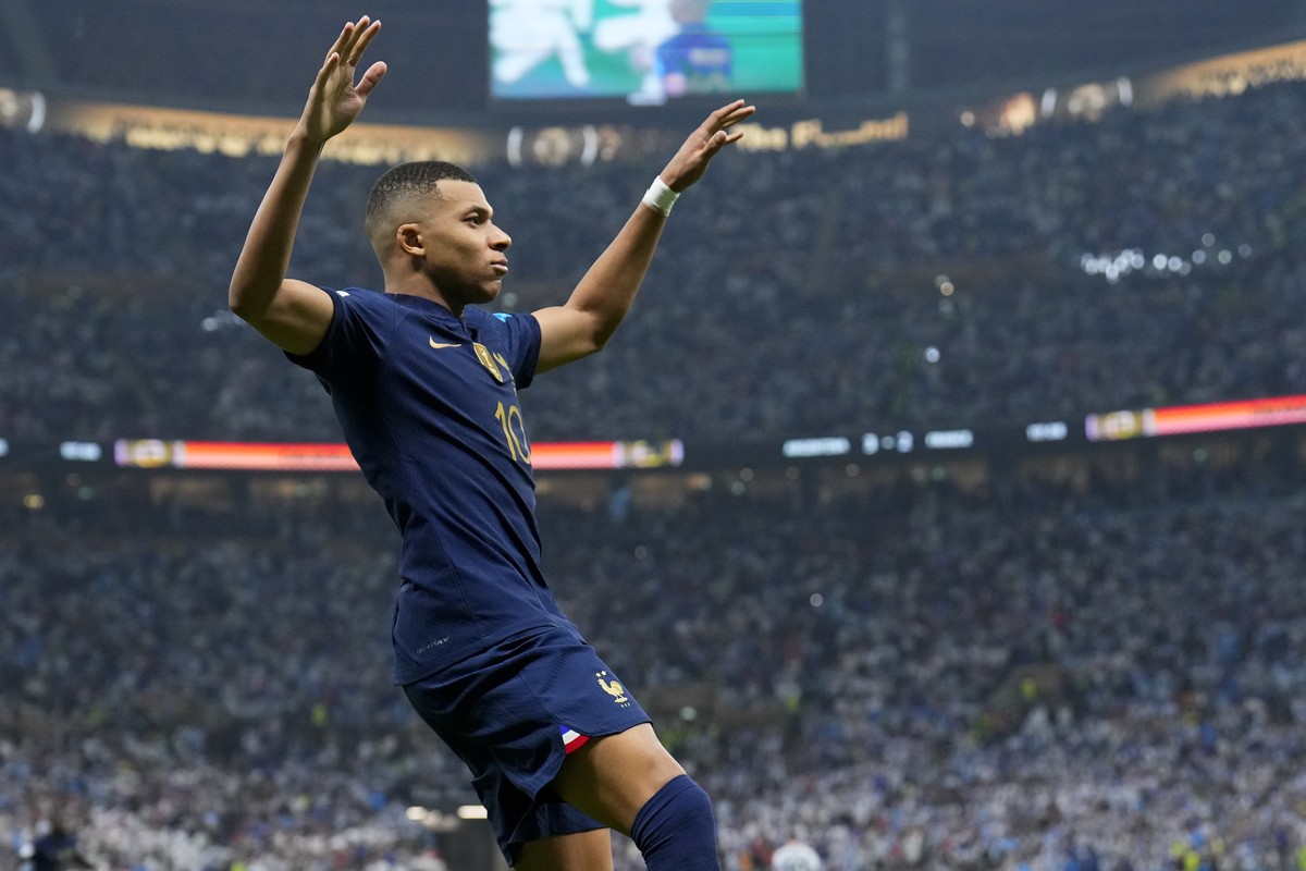 France's Kylian Mbappe celebrates scoring from the penalty spot his side's third goal during the World Cup final soccer match between Argentina and France at the Lusail Stadium in Lusail, Qa ...