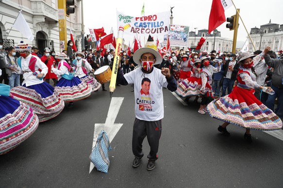 epa09287429 People demonstrate in favor of the leftist leftist Pedro Castillo in Lima, Peru 19 June 2021. Supporters of the leftist Pedro Castillo and Keiko Fujimori took to the streets to defend or c ...
