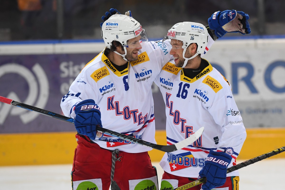 Kloten's player Roman Schlagenhauf, left, and Kloten's player Daniele Grassi, right, celebrate the 3-3, during the preliminary round game of National League Swiss Championship 2017/18 betwee ...