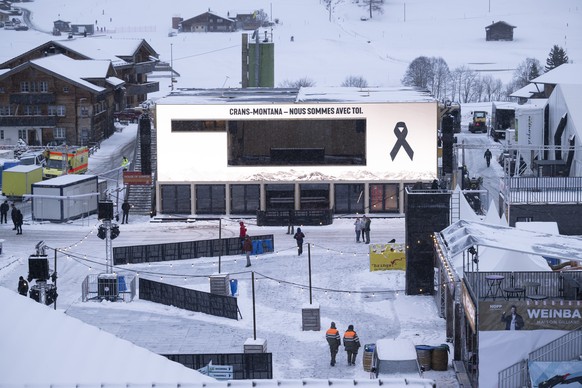 KEYPIX - A screen in tribute to the victims is displayed on the Sunrise House in the World Cup village, during the national day of mourning following the deadly fire at the "Le Constellation&quot ...