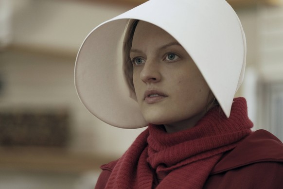 This image released by Hulu shows Elisabeth Moss as Offred in a scene from, "The Handmaid's Tale." Moss is nominated for an Emmy Award for outstanding lead actress in a drama series . T ...