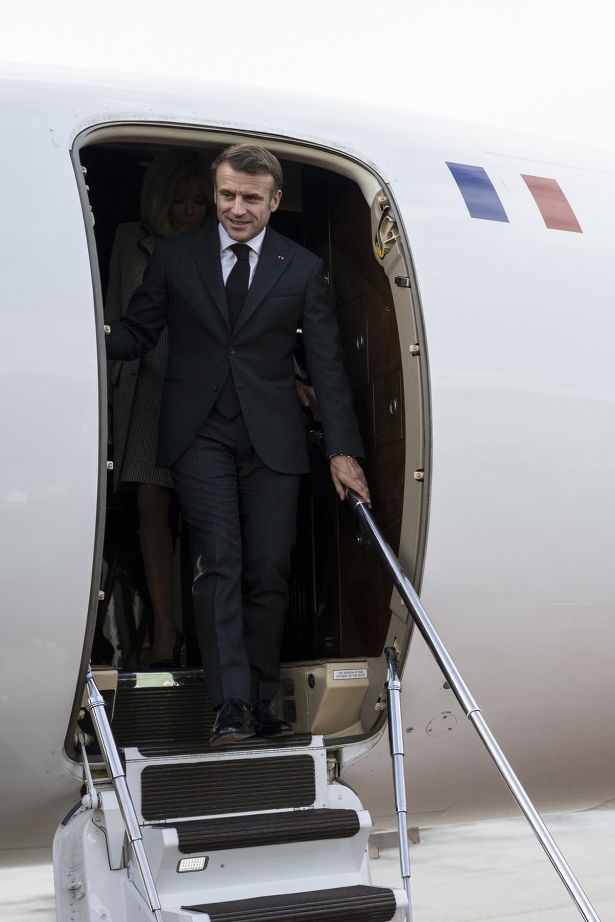 French President Emmanuel Macron, leaves the airplane at the Bern-Belp Airport in Belp, Switzerland, Wednesday, November 15, 2023. French President Macron and his wife Brigitte are visiting Switzerlan ...