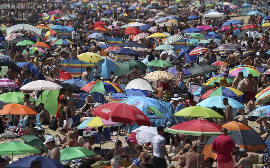 Crowds gather on the beach in Bournemouth, England, Thursday June 25, 2020, as coronavirus lockdown restrictions have been relaxed. According to weather forecasters Thursday could be the UK's hot ...
