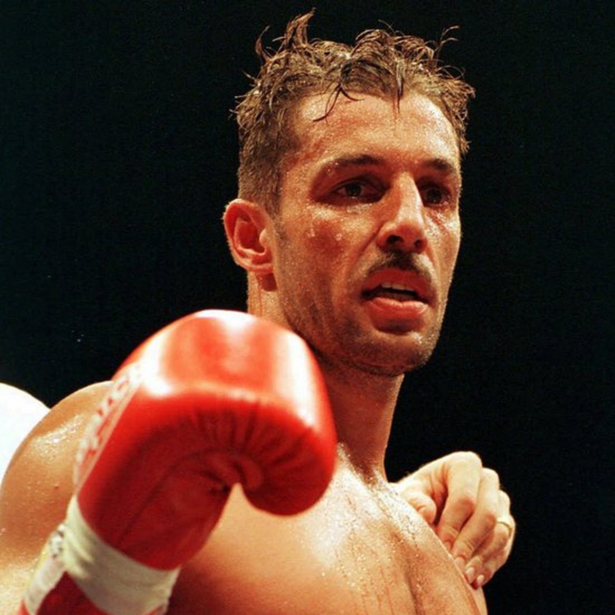 K-1 fighter Andy Hug with the world champion beld on raises his fist after defeating his challenger Peter Aerts from the Netherlands at the K-1 fight night in Zuerich, Switzerland, june 6, 1998. (Keys ...