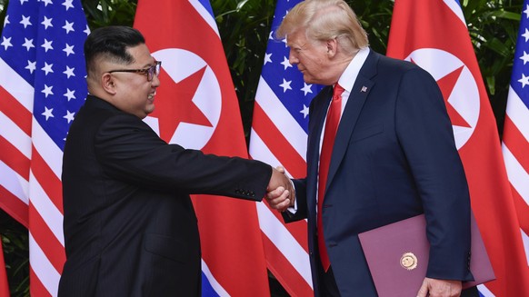 FILE - In this June 12, 2018, file photo, North Korea leader Kim Jong Un, left, and U.S. President Donald Trump shake hands at the conclusion of their meetings at the Capella resort on Sentosa Island  ...