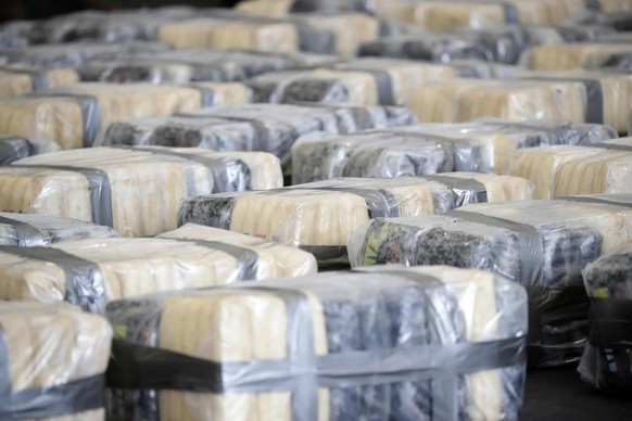epa11376393 Some 2024 kilos of marijuana and 485 kilos of cocaine confiscated during transportation on a manned boat by two costa ricans and a nicaraguan, in San Jose, Costa Rica, 28 May 2024. An oper ...