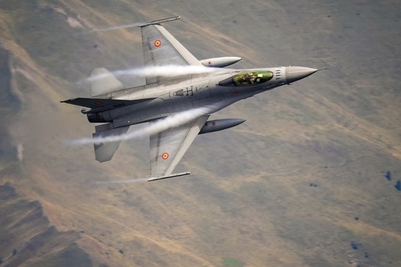 An F-16 Falcon Romanian aircraft flies by during a show of military and acrobatic aviation near the Heroes Cross on Caraiman Peak on top of Bucegi mountains, in Busteni, Romania, Tuesday, Aug. 26, 202 ...