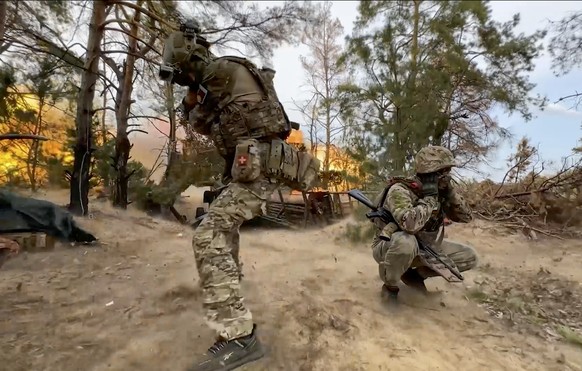 epa11613954 A still image taken from a handout video made available by the Russian Defence Ministry Press-Service on 19 September 2024 shows Russian servicemen firing a &#039;Giatsint-B&#039; towed 15 ...